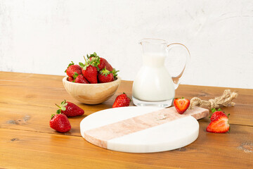 strawberries and bananas on the floor on the wooden table