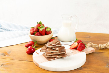 strawberries and bananas on the floor on the wooden table