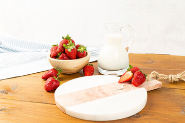 strawberries and bananas on the floor on the wooden table