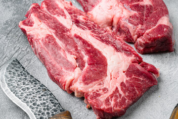 Raw Chuck eye roll steak. Organic beef, on gray stone table background