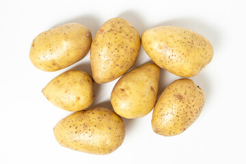 Fototapeta na wymiar Young potatoes on a white background. Raw yellow potatoes. New crop