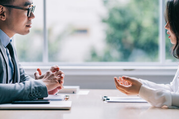 Asian male director is interviewing to recruit new employees