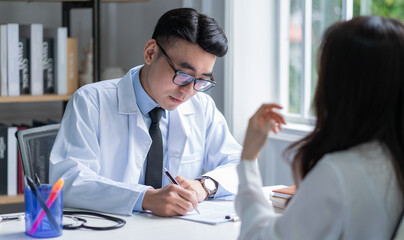 Asian male doctor examining patient at clinic