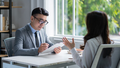 Asian male director is interviewing to recruit new employees
