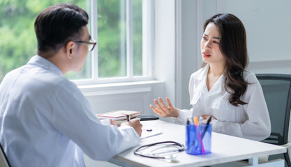 Asian male doctor examining patient at clinic