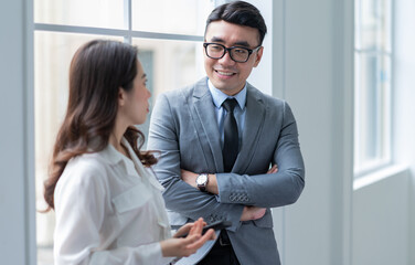 Two Asian businesspeople working at office