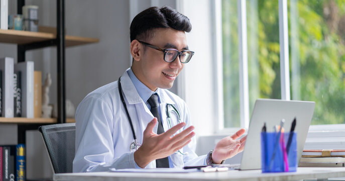 Image of young Asian doctor working at clinic