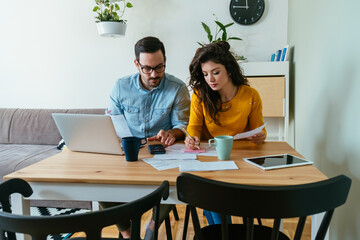 Serious Couple Paying Bills at Home