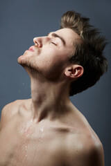 Naklejka premium Getting cleaned up. Cropped shot of a handsome young man posing in the studio.