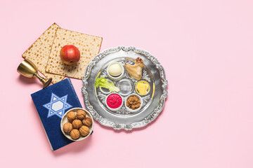 Passover Seder plate with traditional food and Torah on color background, top view