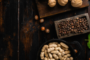 Pine nuts, on old dark  wooden table background, top view flat lay, with copy space for text