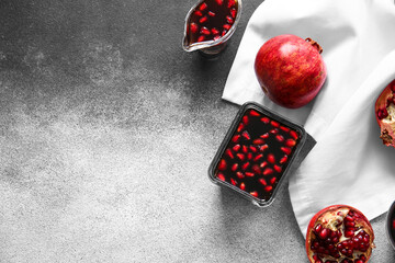 Bowl and gravy-boat of pomegranate molasses on grunge background