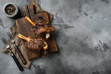 Baked lamb shank with barley and ale, on gray stone table background, top view flat lay, with copy...