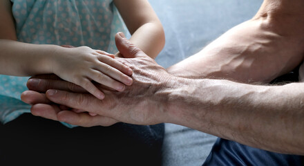 adult male hands holding kid hands, Family Help Care Concept, small hands in fathers hand, touching moment, touch of child and old man, grandfather, parents and child, adopted children, adoption