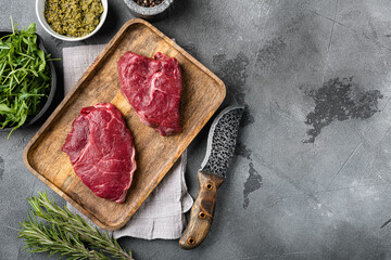 Beef rump meat steak, on gray stone table background, top view flat lay, with copy space for text