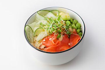 Poke bowl with salmon. Hawaiian cuisine. Healthy food with Omega 3. A dish in a deep bowl.Healthy food. Healthy lifestyle.Lean menu. Isolated object. White background.Copy space.