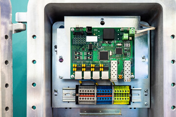 Fragment of electrical equipment. Electronic board is fixed on metal panel. Fragment of electrical...