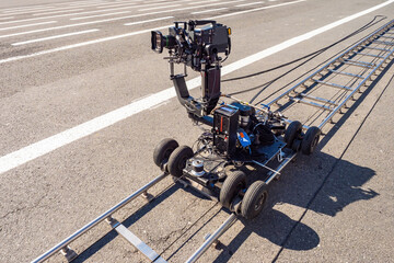 Trolley with professional video camera. Filmmaking equipment. Filming equipment on rails. Concept...