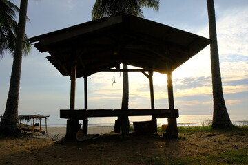 Tropical gazebo on an sandy island beach with coconut palm trees