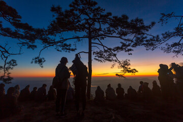 Silhouette of people waiting for sunrise in dawn