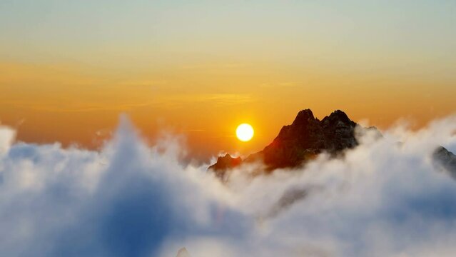 Military helicopter over cumulus clouds at sunset
