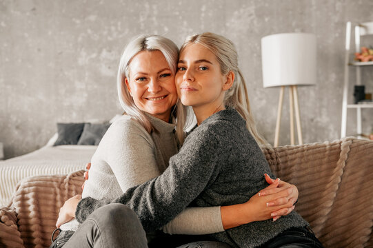 Mother Hugging A Teenage Daughter At Home. Family Relations