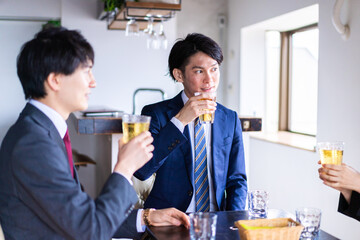 お酒を飲みながら話すビジネスパーソン