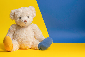 World Down Syndrome Day background. Down syndrome awareness symbol. Teddy bear with different socks...