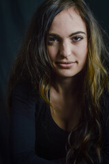 Fototapeta premium Close up portrait of a beautiful Italian woman with long hair and an intense and seductive gaze