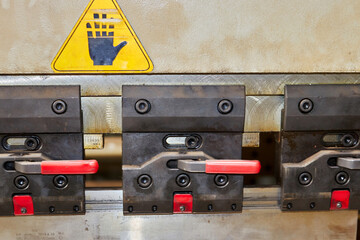 clamps on the machine for bending metal products