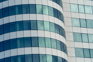 Fototapeta na wymiar view of Glass building facade , Modern office facade fragment with blue green glass