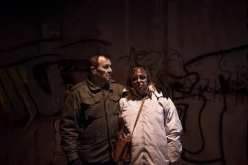 Older couple standing together in a old nuclear shelter