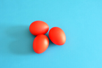 red easter eggs on blue background, close-up