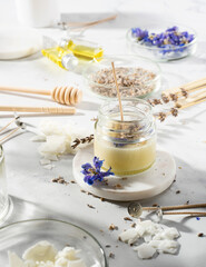 Set tools for homemade natural eco-friendly soy wax candles, wick, perfume, essential oil on a marble table. Making process. Trendy DIY. Craft hobby, small business, artisan products concept
