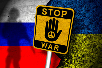 stop war sign in front of russian and ukraine flag paint on wall.