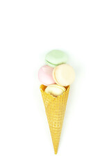 Delicious in the form of a waffle cone filled marshmallows looks like macaroons on a white background.