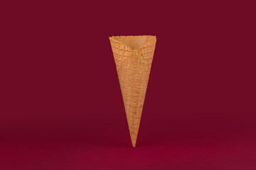 Blank of ice cream cone, waffle cup on red background, close up.