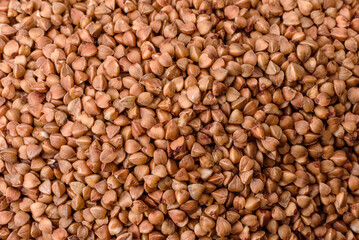 Bio buckwheat cereals raw food background, texture close up