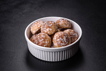 Tasty homemade gingerbread cookies on dark concrete table