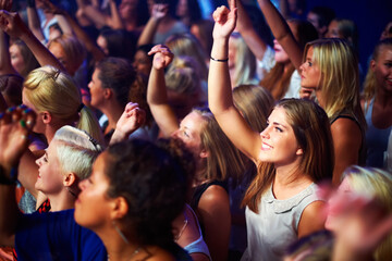 A group of adoring fans singing along to their favorite song. This concert was created for the sole purpose of this photo shoot, featuring 300 models and 3 live bands. All people in this shoot are - obrazy, fototapety, plakaty