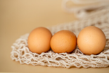 organic chicken eggs lie on a string bag