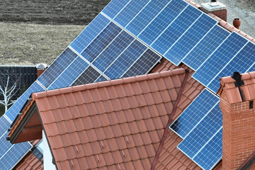 Aerial view building roof with rows of blue solar photovoltaic panels for producing clean ecological electric energy. Renewable electricity with zero emission concept