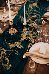 Elegant wedding table decor in gold and green tones