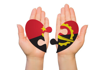 Woman hands are holding two parts of puzzle heart. National concept on white background. Angola