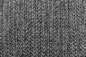The fabric is dense gray with straight geometric lines and stitching. Dark color material for furniture upholstery, tailoring