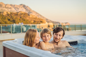 Portrait of young carefree happy smiling happy family relaxing at hot tub during enjoying happy...