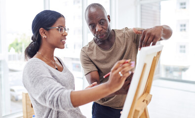 Hes the best art teacher in town. Cropped shot of a woman talking to her teacher in a art class.