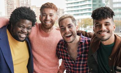 Group of young diverse men smiling on camera in the city - Multiracial male friendship concept - Powered by Adobe