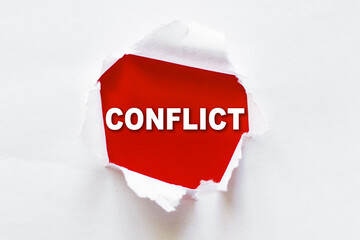 Word CONFLICT write under torn paper on red