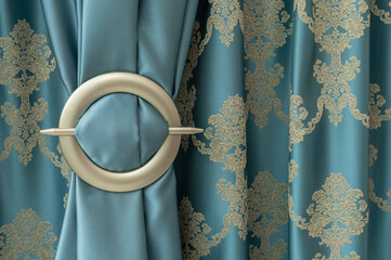 Beautiful turquoise curtain, fastened with an iron tie